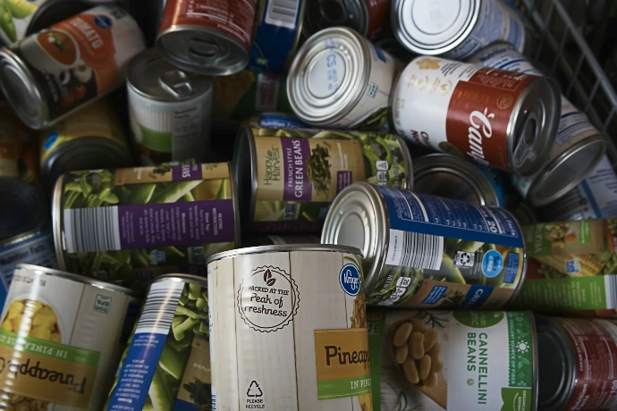 A pile of cans of food sitting next to each other